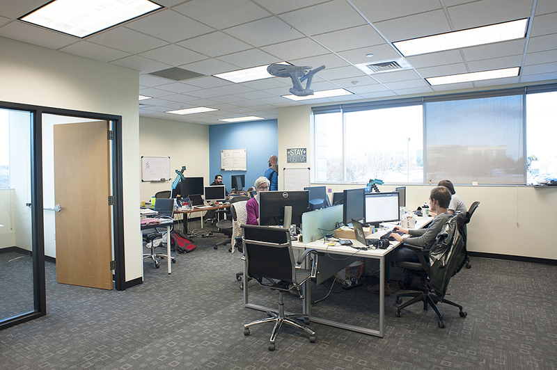 Ten Forward employees work at their desks in the newly expanded space.